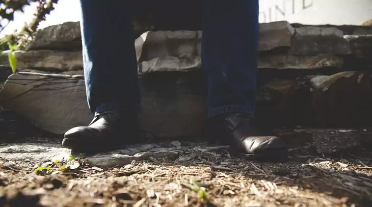 Man in jeans sitting down and taking a break