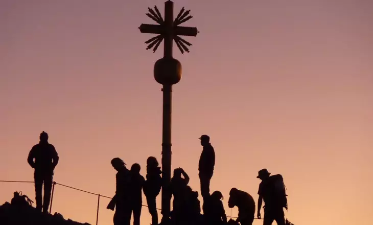 group of people hiking on the mountains together