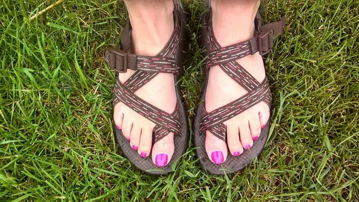 A woman s legs wearing a pair of hiking sandals