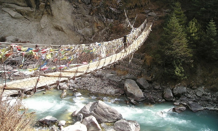 A man passing a bridge in Nepal