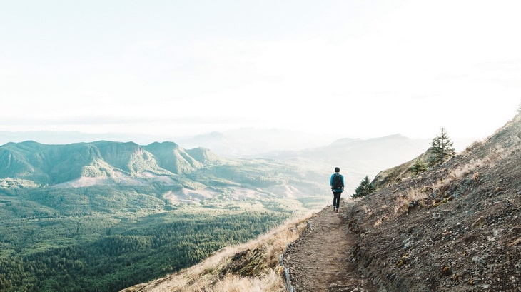 Man Walking on Cliff during Daytime