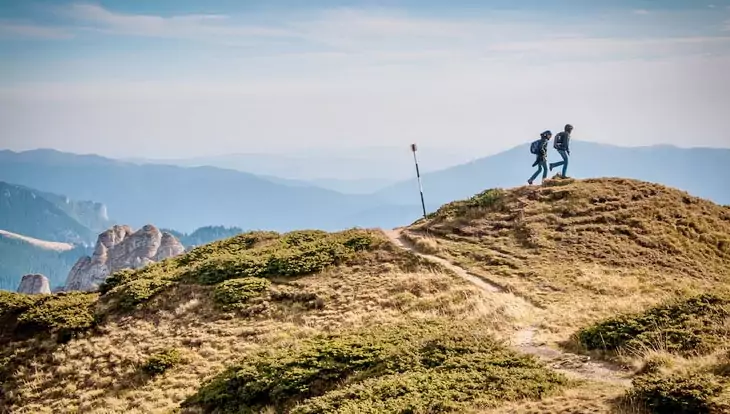 2 Person Hiking on Top of a Hill during Daytime