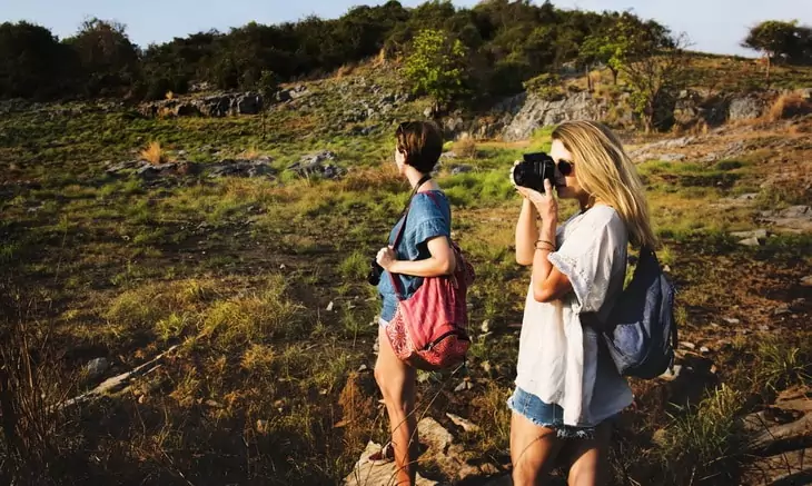 Two hikers taking pictures on the trail