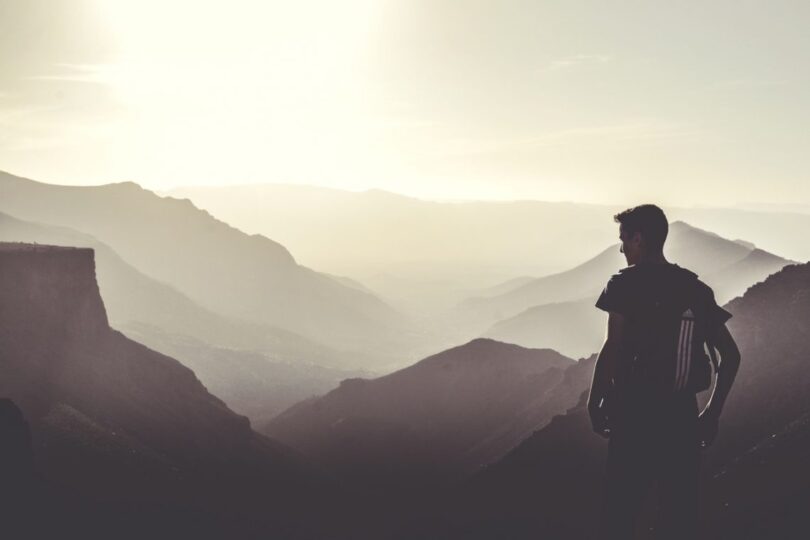 Man Wearing Black Tops at the Top of the Mountain