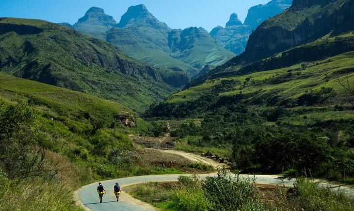 2 People in Grey Road Near the Mountain during Daytime