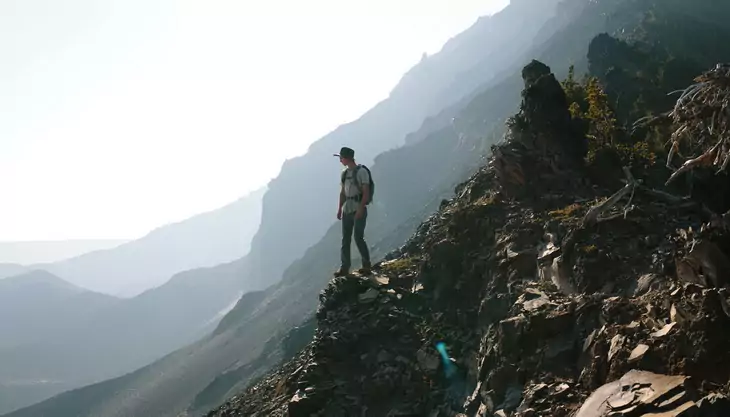 hiker on top of the mountain watching the landscape