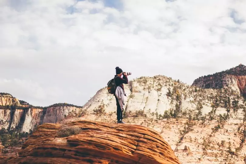 photographer in the top of the mountains taking a photo