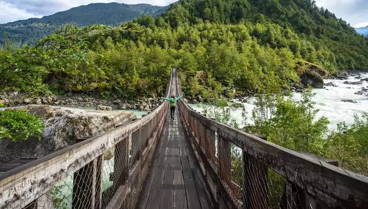 hiker passing queulat bridge