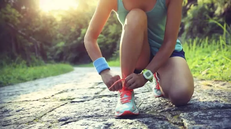 Woman lacing her shoes