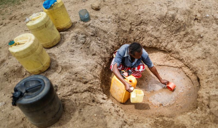 Woman Burrowing for Water in desert