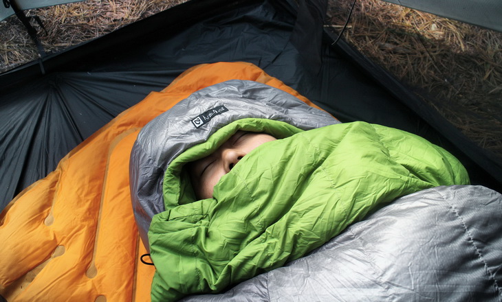 Woman sleeping in a Nemo sleeping bag in the nature