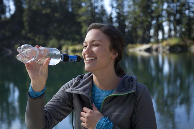 girl drinking with sawyer mini filter with bottle