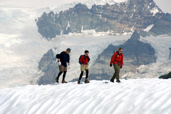 Hikers climbing in snowy mountains in Alaska