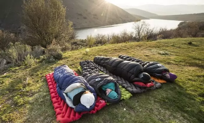 Four aduls in sleeping bags in the morning