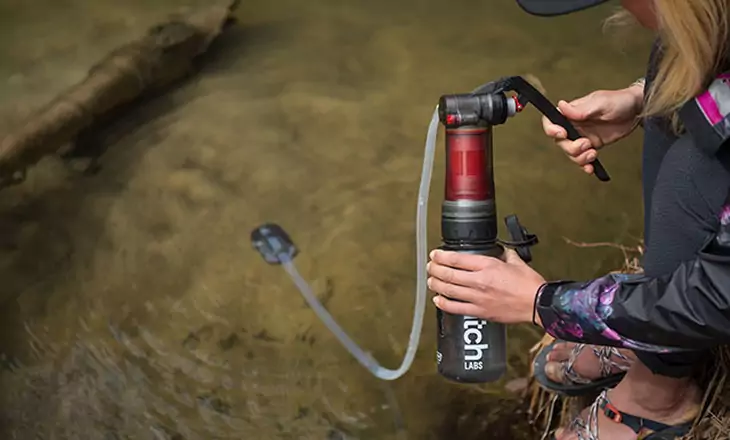 Woman with a water filter system