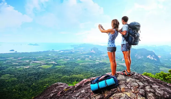 Backpackers on top of the mountains taking a selfie