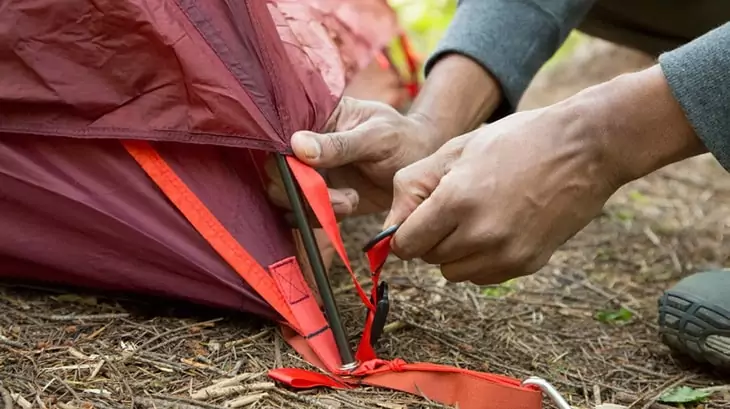 Man setting up a tent
