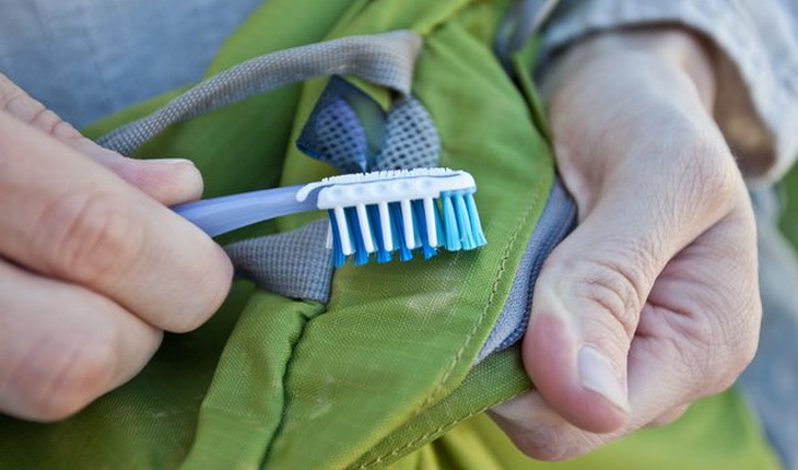 Cleaning sleeping bag with a toothbrush