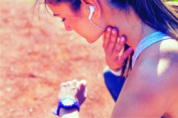 Girl measuring pulse while exercising