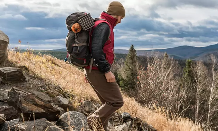 Man with a backpack walking on the trail