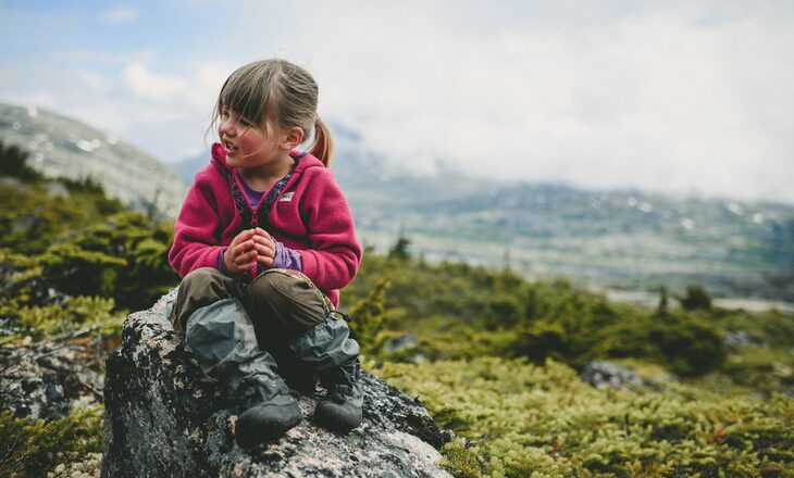 Little girl talking with her parents while resting