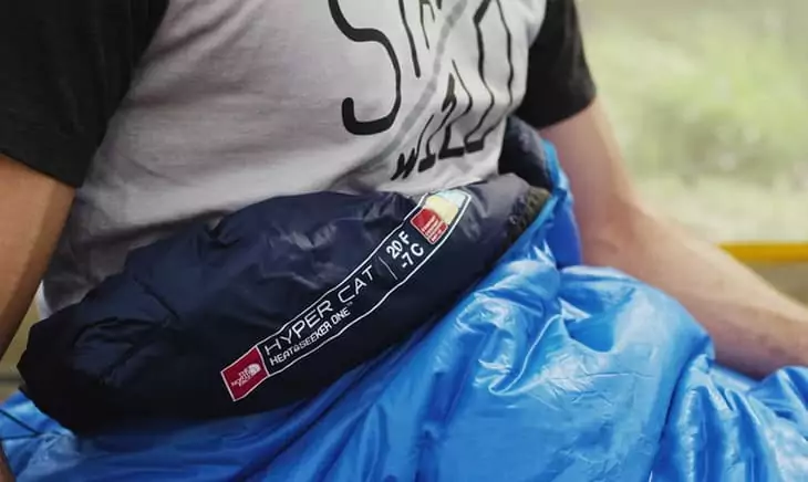 A man in the North Face HyperCat 20, which is crafted with a durable and lightweight synthetic insulation