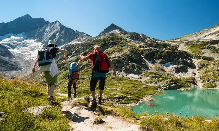 Parents hiking with their children in the summer