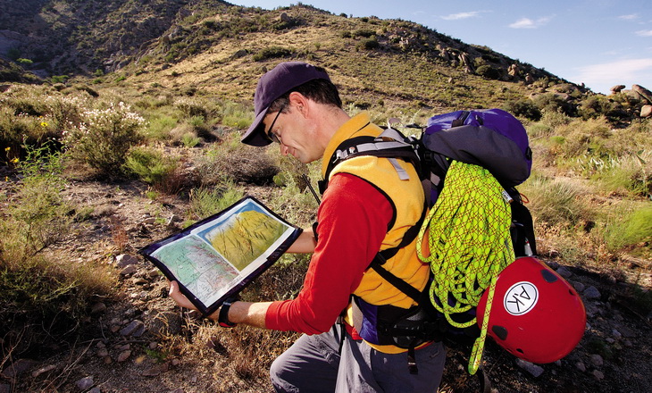 Backpacker looking at a map