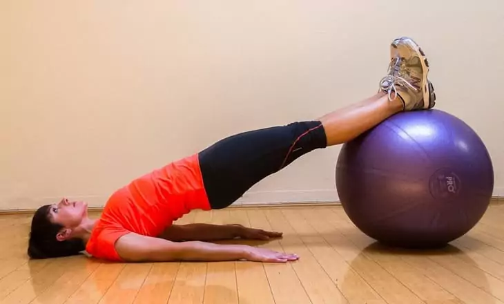 Woman performing Stability Ball Glute Bridge Exercise