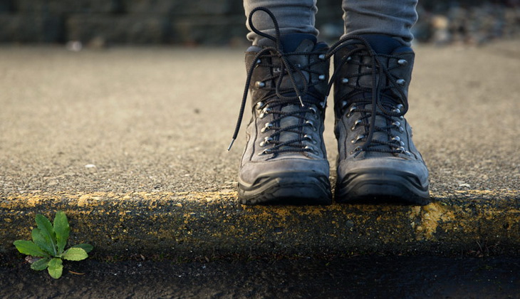 Image of a person sitting in hiking boots