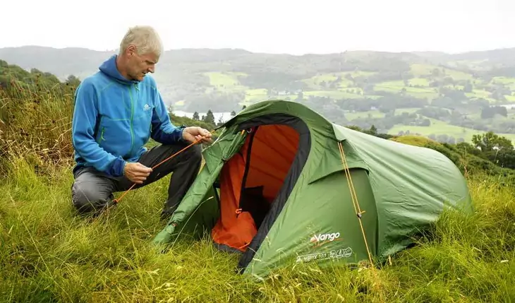 A man setting up Vango Helix 100 solo tent