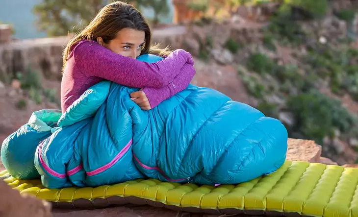 Woman relaxing outside in a sleeping bag