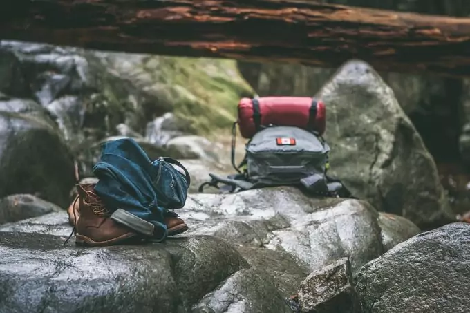 Extra clothes and food in a backpack on a rock