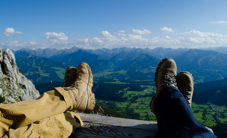 two persons laying on the ground and watching the view