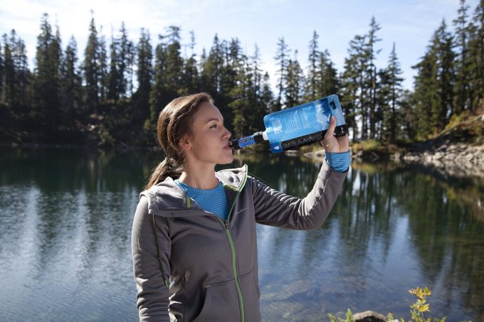 girl drinking from sawyer mini water filter
