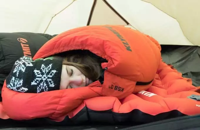 girl-sleeping-in-down-bag