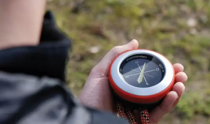 GPS with compass in hands of a person