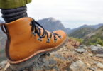 hiker wearing hiking boots and a landscape in the background