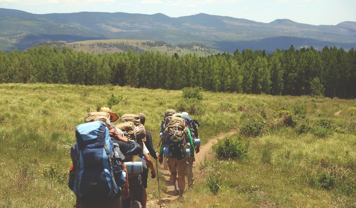 backpackers on a mountain trail in the daytime