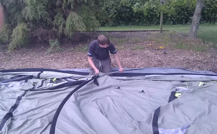 A man pitching a tent