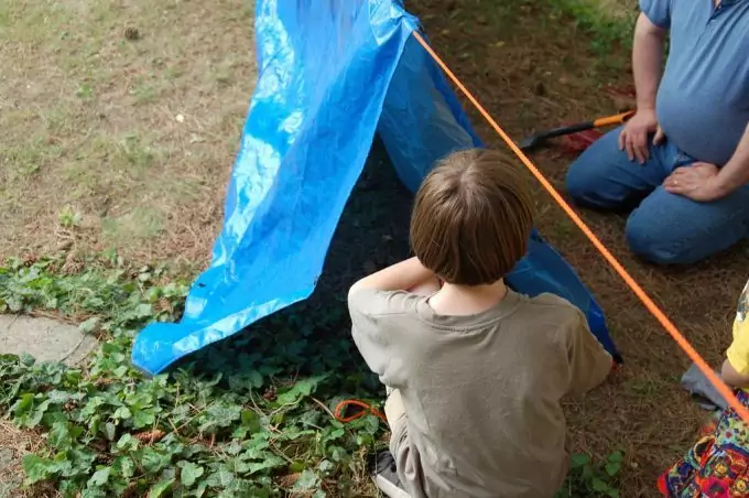 kid-and-dad-making-tarp-tent-