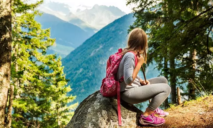 little-girl-hiking-and-resting-on-a-rock