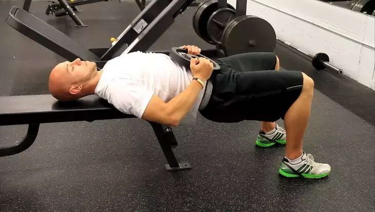 A Man Showing Bench Supported Glute Bridge Exercise