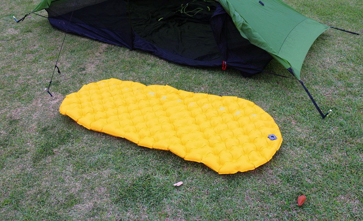 Sea to Summit Ultralight Mat on the grass next to a tent