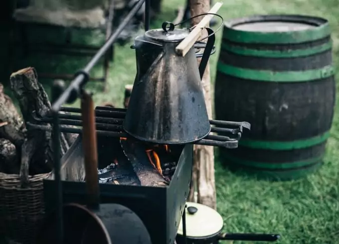 A campfire and a kettle full of water