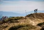 2 Person Hiking on Top of a Hill during Daytime