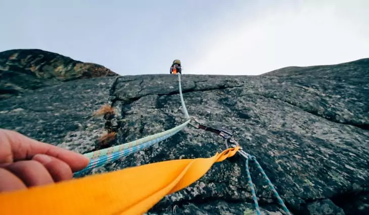 Two persons climbing during daylight