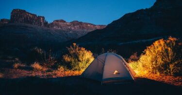 A tent outside in the nature during night time