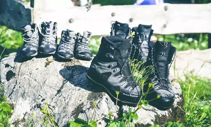 hiking boots on a rock in the sun during day time