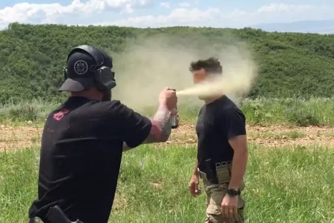 repelling bear spray on person